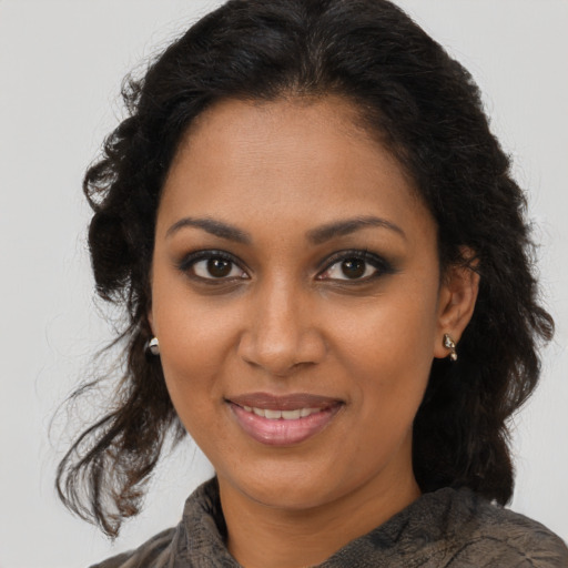 Joyful black young-adult female with medium  brown hair and brown eyes