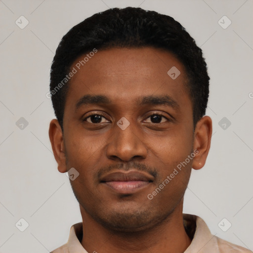 Joyful black young-adult male with short  black hair and brown eyes