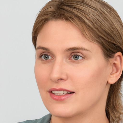 Joyful white young-adult female with medium  brown hair and blue eyes