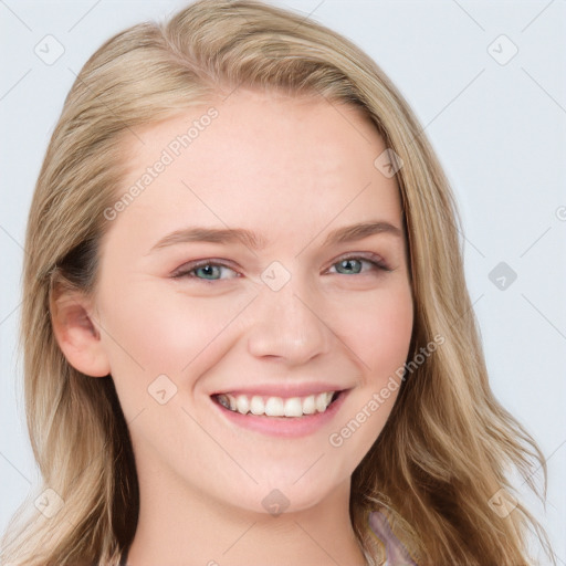 Joyful white young-adult female with long  brown hair and blue eyes