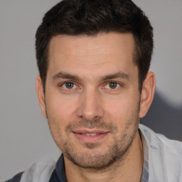 Joyful white adult male with short  brown hair and brown eyes