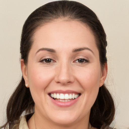 Joyful white young-adult female with long  brown hair and brown eyes