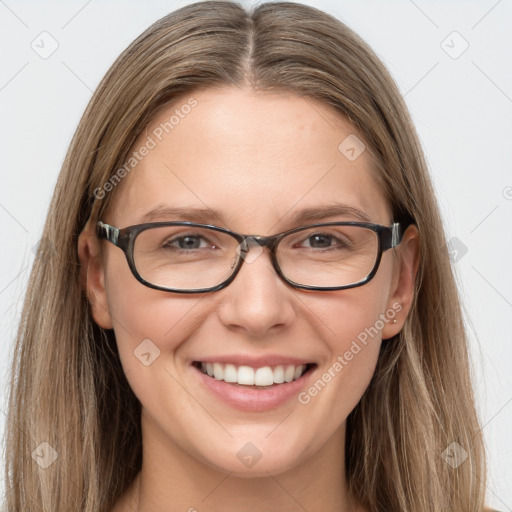 Joyful white young-adult female with long  brown hair and blue eyes