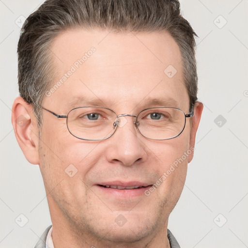 Joyful white adult male with short  brown hair and grey eyes