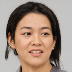 Joyful asian young-adult female with medium  brown hair and brown eyes