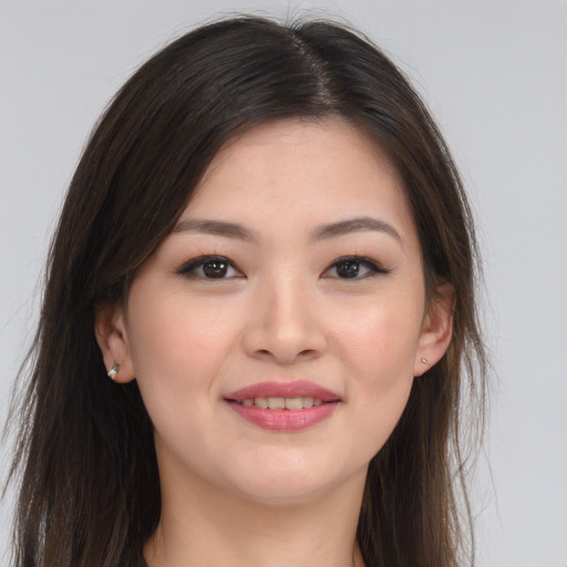 Joyful asian young-adult female with long  brown hair and brown eyes