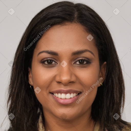 Joyful black young-adult female with long  brown hair and brown eyes