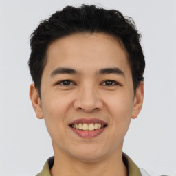 Joyful asian young-adult male with short  brown hair and brown eyes