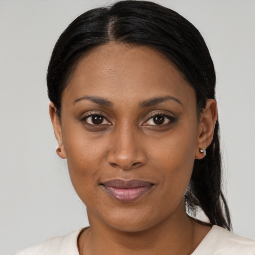 Joyful latino young-adult female with medium  black hair and brown eyes