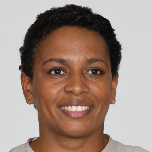 Joyful black adult female with short  black hair and brown eyes