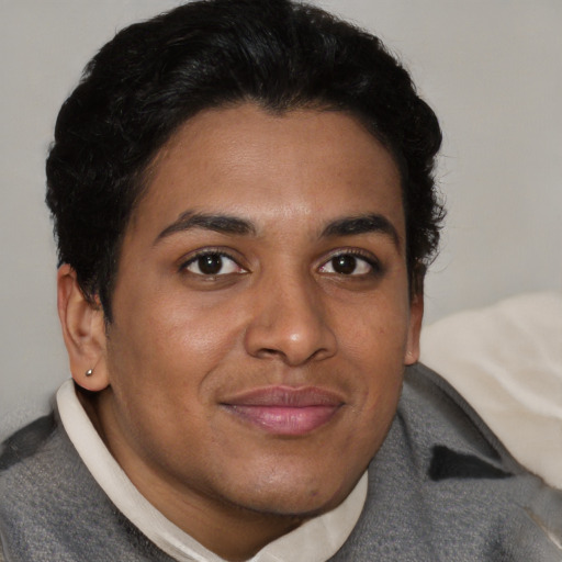 Joyful latino young-adult male with short  brown hair and brown eyes