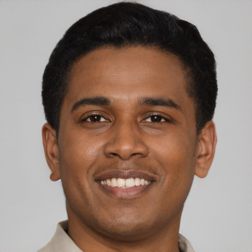 Joyful latino young-adult male with short  black hair and brown eyes