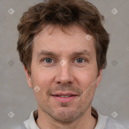 Joyful white adult male with short  brown hair and grey eyes