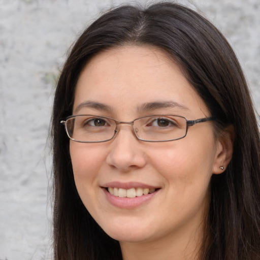 Joyful white adult female with long  brown hair and brown eyes