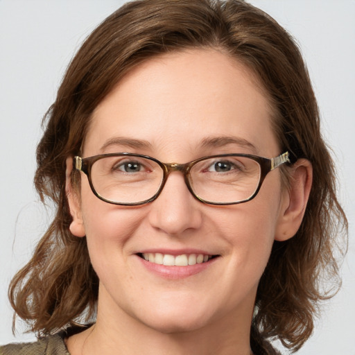 Joyful white young-adult female with medium  brown hair and blue eyes