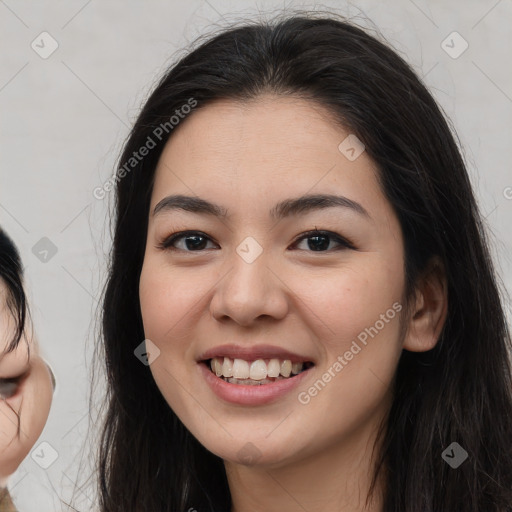 Joyful asian young-adult female with long  brown hair and brown eyes