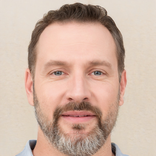 Joyful white adult male with short  brown hair and grey eyes