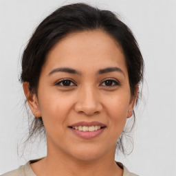 Joyful latino young-adult female with medium  brown hair and brown eyes