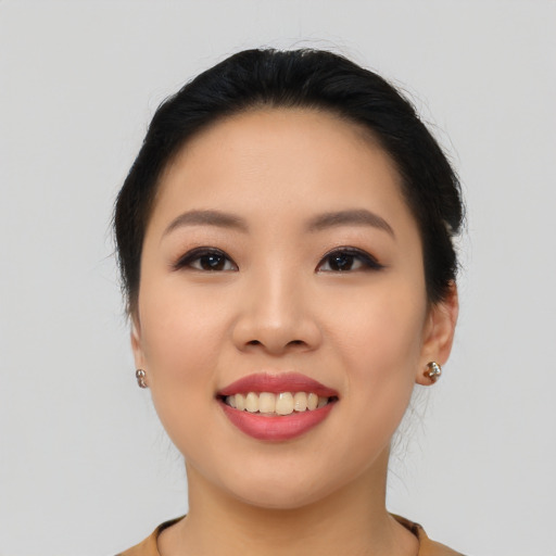 Joyful asian young-adult female with long  black hair and brown eyes