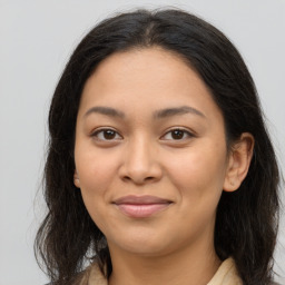 Joyful latino young-adult female with long  brown hair and brown eyes