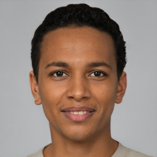 Joyful black young-adult male with short  black hair and brown eyes