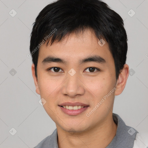 Joyful asian young-adult male with short  black hair and brown eyes