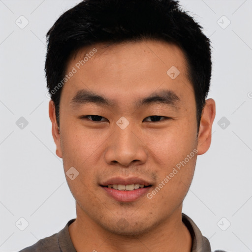 Joyful asian young-adult male with short  black hair and brown eyes