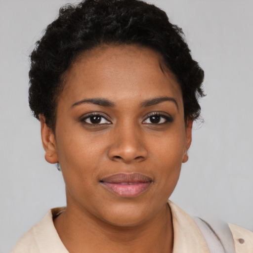 Joyful black young-adult female with short  brown hair and brown eyes