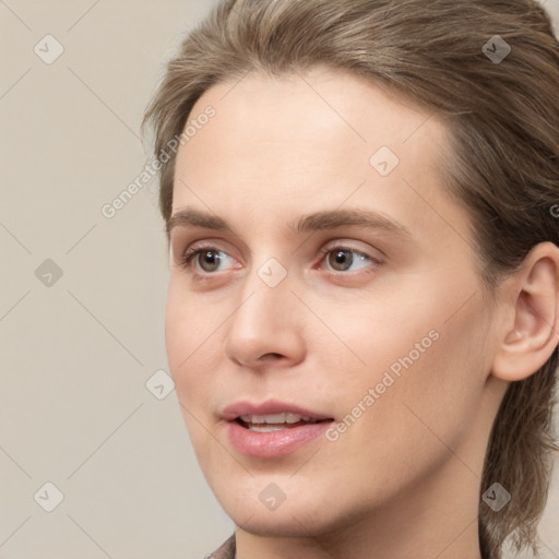 Joyful white young-adult female with medium  brown hair and grey eyes