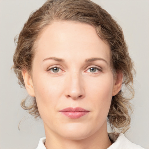 Joyful white young-adult female with medium  brown hair and green eyes