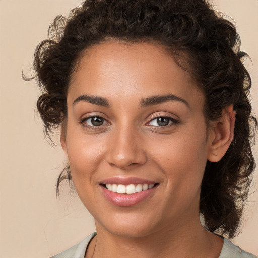 Joyful white young-adult female with medium  brown hair and brown eyes