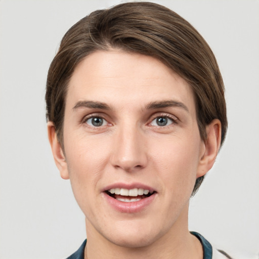 Joyful white young-adult male with short  brown hair and grey eyes