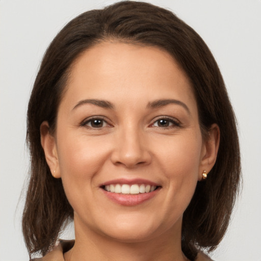 Joyful white young-adult female with medium  brown hair and brown eyes