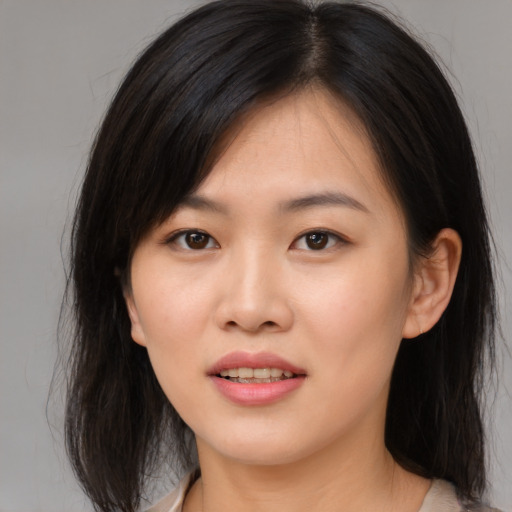 Joyful asian young-adult female with medium  brown hair and brown eyes