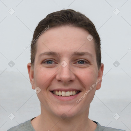 Joyful white young-adult female with short  brown hair and grey eyes