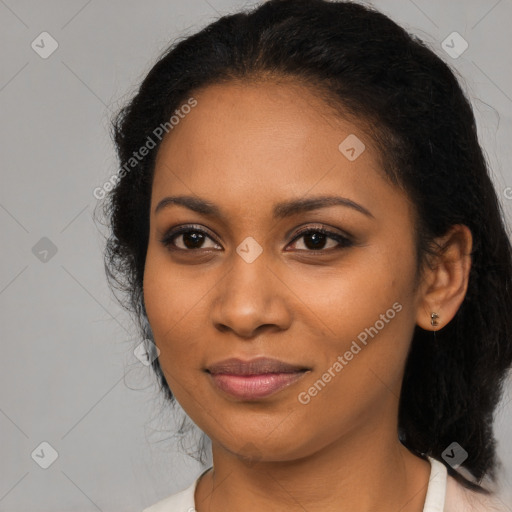 Joyful black young-adult female with long  black hair and brown eyes