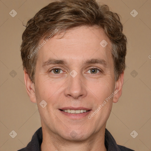 Joyful white adult male with short  brown hair and grey eyes