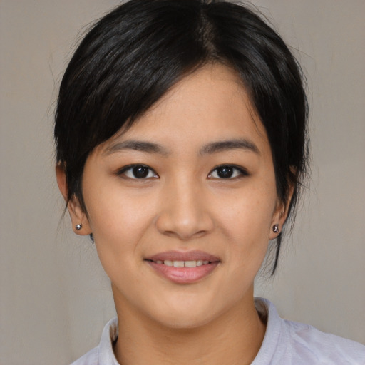 Joyful asian young-adult female with medium  black hair and brown eyes