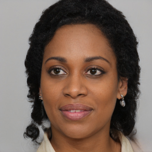 Joyful black young-adult female with medium  brown hair and brown eyes