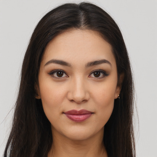 Joyful latino young-adult female with long  brown hair and brown eyes