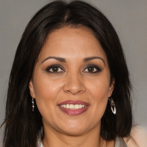 Joyful white adult female with long  brown hair and brown eyes