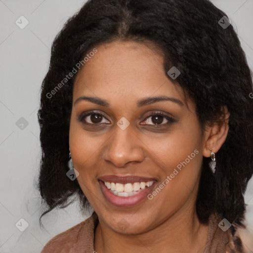 Joyful black young-adult female with long  brown hair and brown eyes