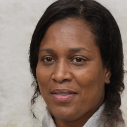 Joyful black adult female with medium  brown hair and brown eyes