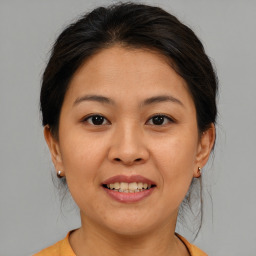 Joyful asian young-adult female with medium  brown hair and brown eyes