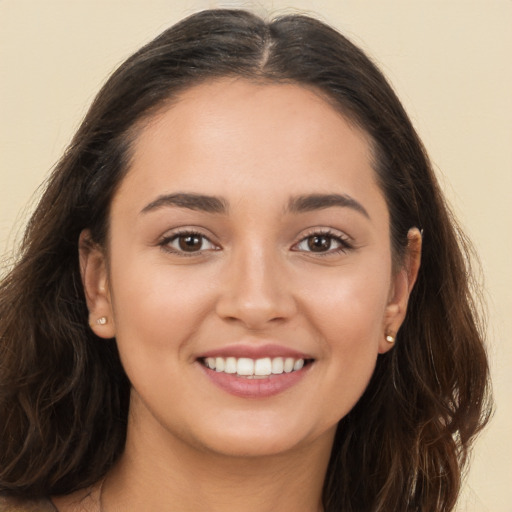 Joyful white young-adult female with long  brown hair and brown eyes