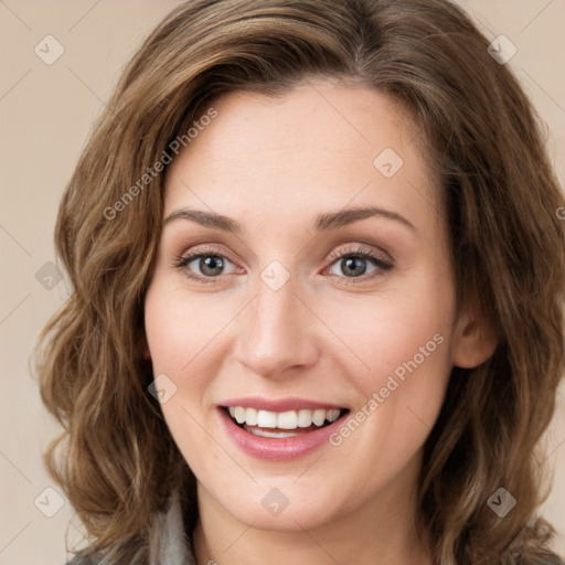 Joyful white young-adult female with medium  brown hair and green eyes