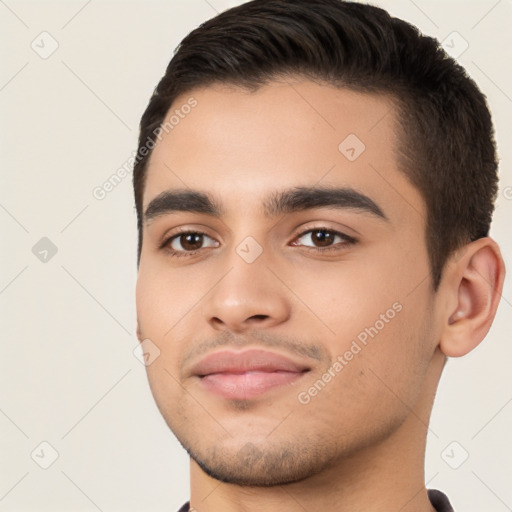 Joyful white young-adult male with short  black hair and brown eyes