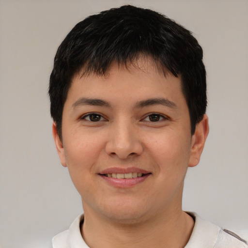 Joyful white young-adult male with short  black hair and brown eyes