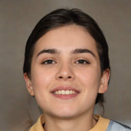 Joyful white young-adult female with medium  brown hair and brown eyes