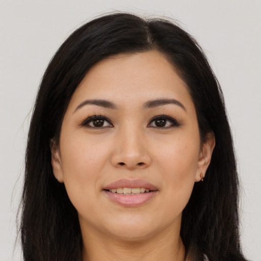 Joyful latino young-adult female with long  brown hair and brown eyes